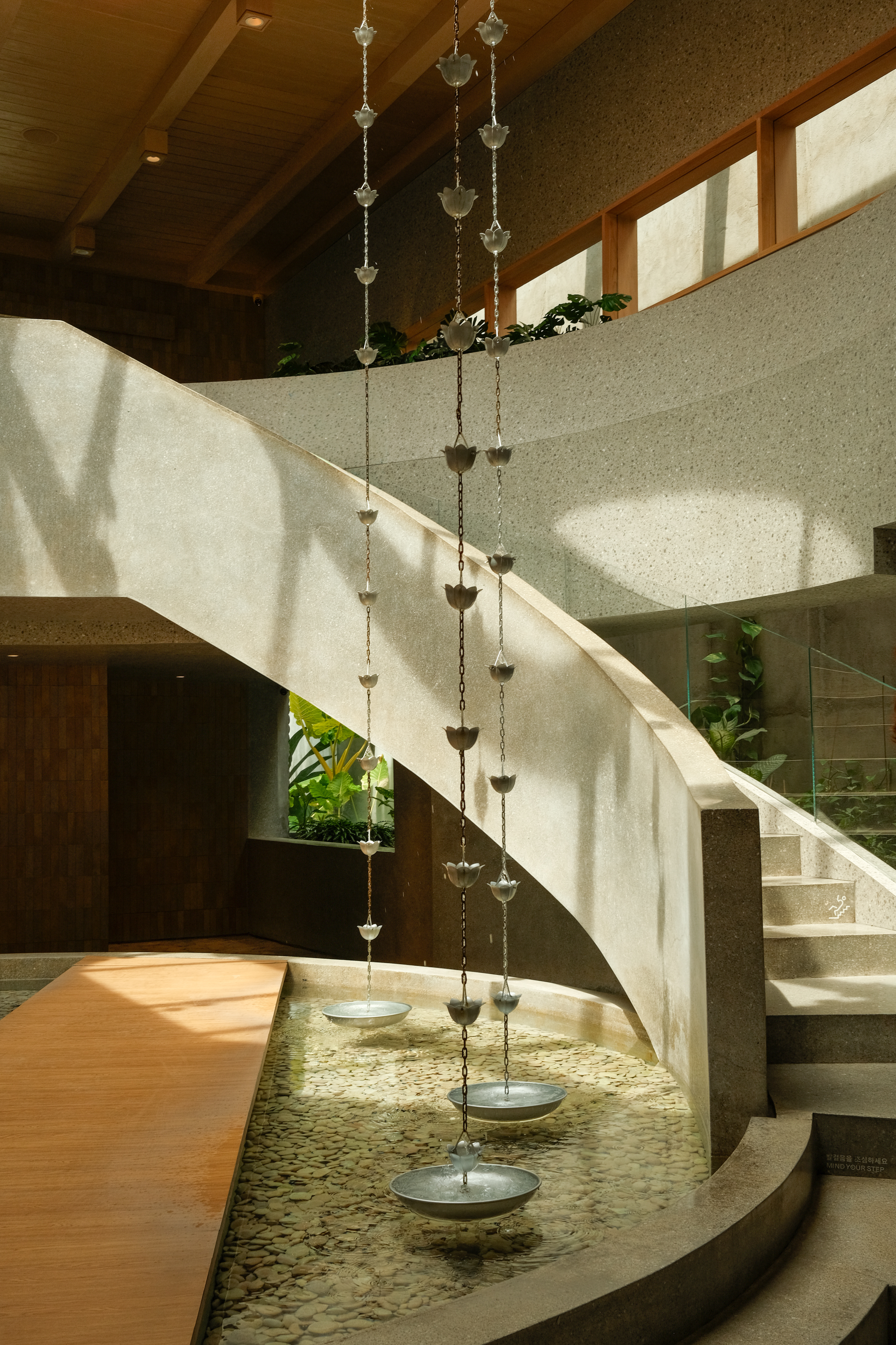 Sunlit architectural stair and water feature